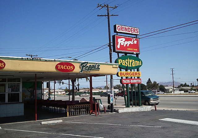Peppi's restaurant with various food signs.