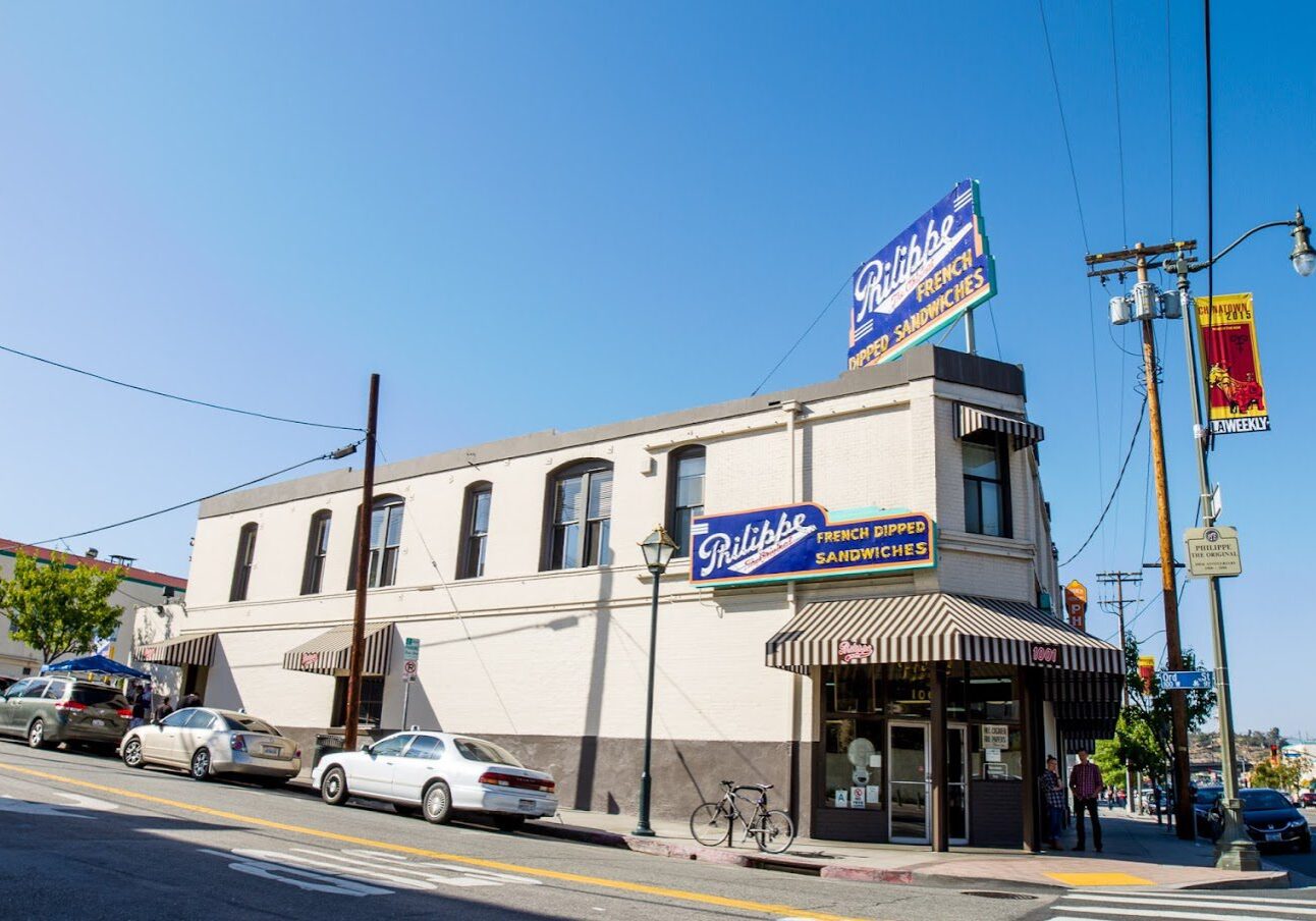 Exterior view of a two-story vintage diner on a sunny day.