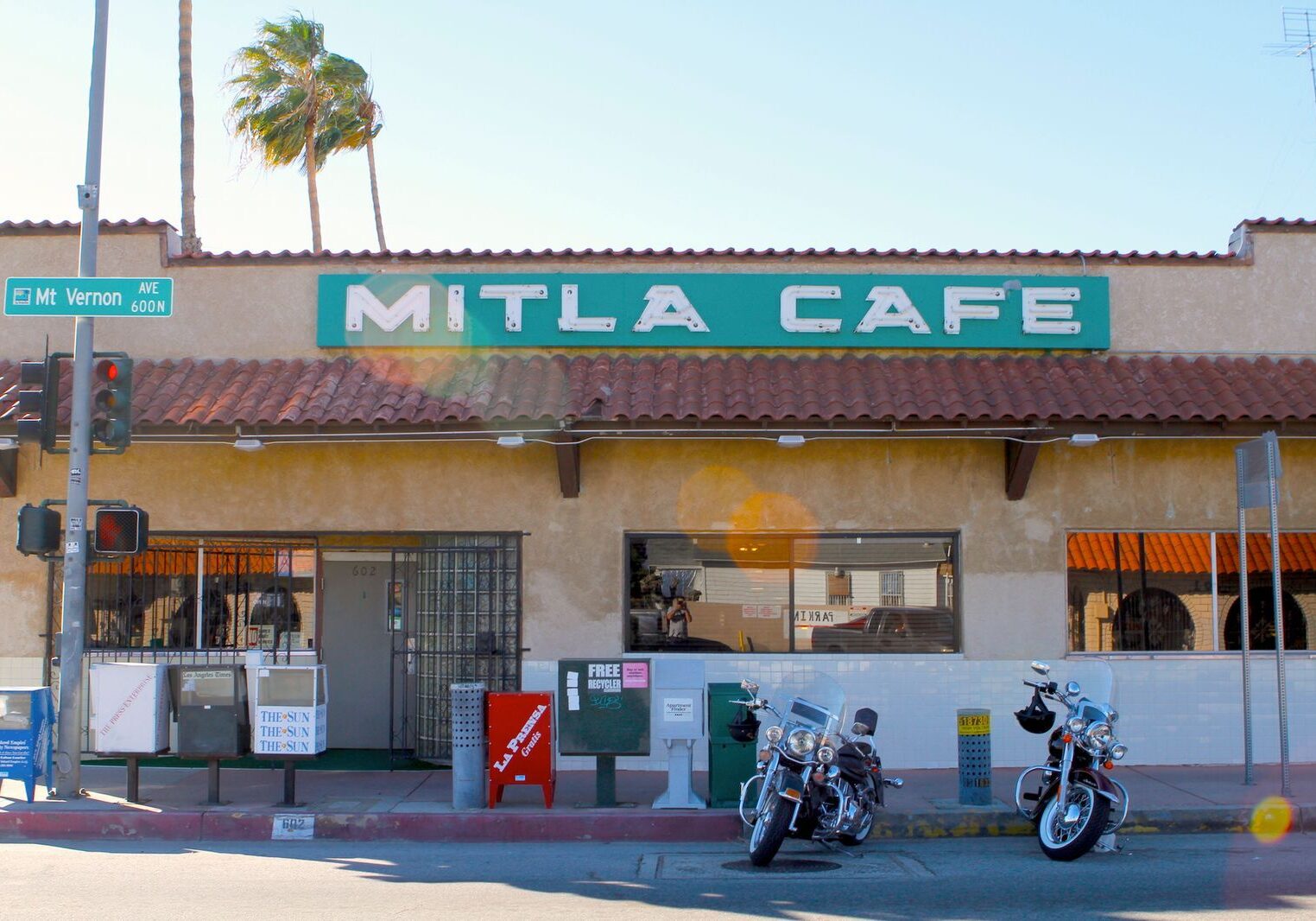 Exterior of Mitla Cafe with motorcycles parked outside.