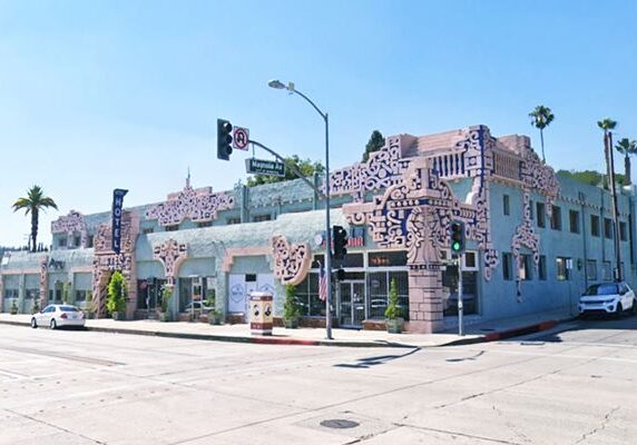 Art Deco building on a sunny street corner.